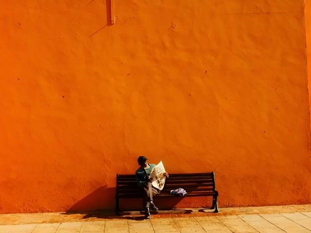 Man Tying Shoe and Walking Away
