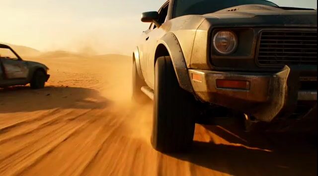 Tracking shot of armored muscle car in desert